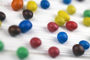 KHARKIV, UKRAINE - JANUARY 2, 2021 M and Ms colorful button shaped chocolate candies. Multi colored chocolates each of which has the letter m printed in lower case in white photo