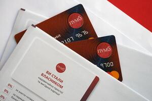 TERNOPIL, UKRAINE - JULY 7, 2023 Bank Card of PUMB Ukrainian Bank FUIB with red logo photo