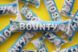 KYIV, UKRAINE - OCTOBER 31, 2023 Bounty chocolate bars with cocoa flavor filling. Bounty chocolate bar is a brand of American Mars Inc photo