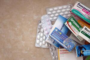 KYIV, UKRAINE - 4 MAY, 2023 Many boxes of pills and capsules stacked in pharmacy drug store photo