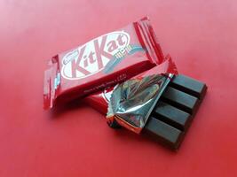 KHARKIV, UKRAINE - JANUARY 2, 2021 Kit Kat by Nestle chocolate covered wafer on bright color photo