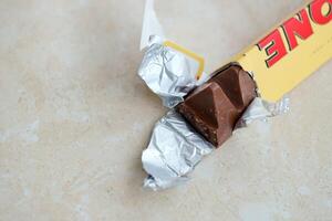 KYIV, UKRAINE - OCTOBER 31, 2023 Yellow Toblerone Chocolate Bar. Toblerone originated in Switzerland around 1908 photo