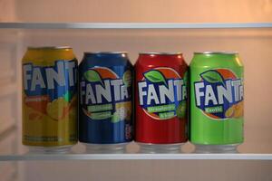 KYIV, UKRAINE - 4 MAY, 2023 Fanta soft drink brand tin cans with various flavours photo