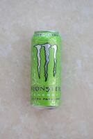 KYIV, UKRAINE - 4 MAY, 2023 Monster energy drink ultra paradise in green tin can with Monster energy drink logo photo