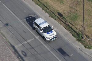 TERNOPIL, UKRAINE - JULY 7, 2023 Ukrainian patrol police white car with police lights and decals in daytime photo