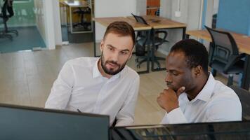 Two stock traders working in the office with exchange technology video