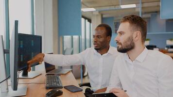 Two stock traders working in the office with exchange technology video