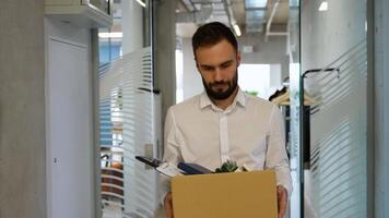 Dismissed worker leaving or resign or dismiss from job, man carry personal box walking out from office video