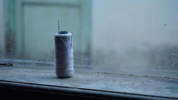 Threads and needles on the window photo