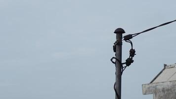 Electricity connection pole between houses on the roof photo