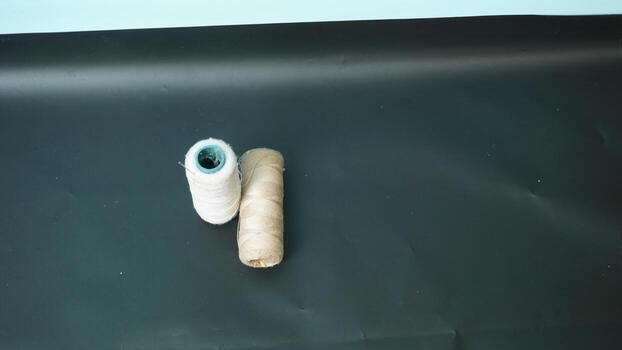 Spool of threads with needles on plain background. photo