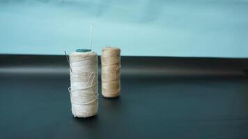 Spool of threads with needles on plain background. photo