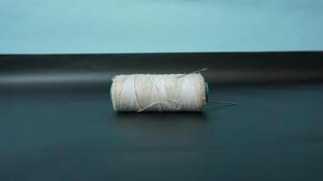 Spool of threads with needles on plain background. photo