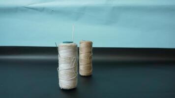 Spool of threads with needles on plain background. photo