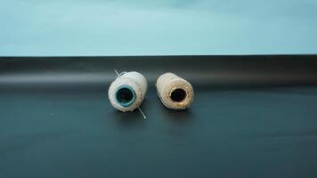 Spool of threads with needles on plain background. photo