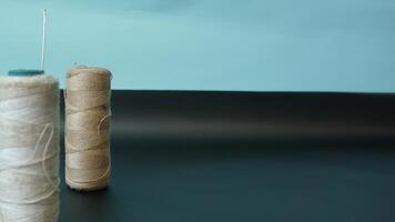 Spool of threads with needles on plain background. photo