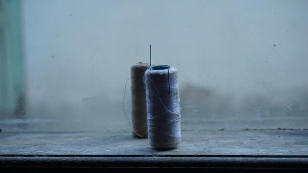 Threads and needles on the window photo