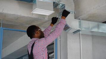 Professional Black Heating and Cooling Technician Worker Finishing Newly Assembled Air Vent Shaft video