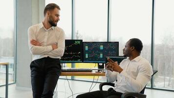 Two crypto traders making professional analysis of candlestick chart, creating strategy, looking at monitor video