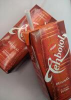 Sulawesi, Indonesia, January 21st, 2023. Sosro bottle tea, packaged tea drink, one of the popular drink brands in Indonesia in a red box. Sometimes served during Ramadan or Eid al-Fitr photo