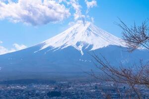 Mountain Fuji of snow on top in japan with blue sky and clouds view background photo