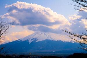 Mount Fuji, large clouds covering the top of the mountain.Landscape View With Water At Kawaguchiko Lake, Japan photo