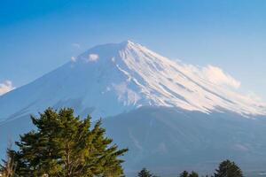 Mountain Fuji of snow on top in japan with blue sky and clouds view background photo