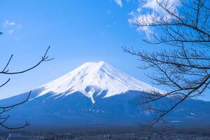 Mountain Fuji of snow on top in japan with blue sky and clouds view background photo