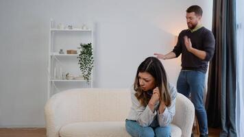 Domestic violence and abuse concept. Abusive husband arguing wife, jealous distrustful dominant man shouting at sad woman video