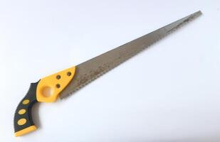 Hand saw with yellow plastic handle photo