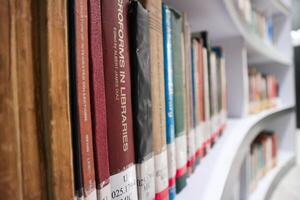 JAKARTA, INDONESIA - DECEMBER, 20 2023, a collection of books neatly arranged on a library shelf photo