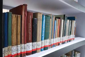 JAKARTA, INDONESIA - DECEMBER, 20 2023, a collection of books neatly arranged on a library shelf photo