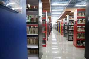 JAKARTA, INDONESIA - DECEMBER, 20 2023, a collection of books neatly arranged on a library shelf photo