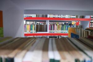 JAKARTA, INDONESIA - DECEMBER, 20 2023, a collection of books neatly arranged on a library shelf photo