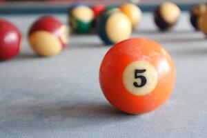 Billiards sports game. Multi-colored billiard balls with numbers on the pool table. Active recreation and entertainment. photo
