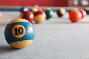 Billiards sports game. Multi-colored billiard balls with numbers on the pool table. Active recreation and entertainment. photo