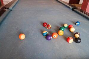 Billiards sports game. Multi-colored billiard balls with numbers on the pool table. Active recreation and entertainment. photo