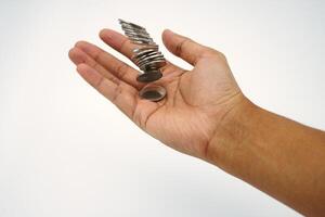 Small salary. Hand holding and receiving coin money on white background photo