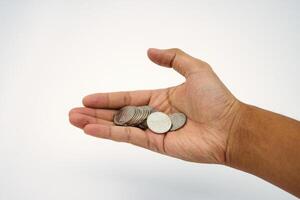 Small salary. Hand holding and receiving coin money on white background photo