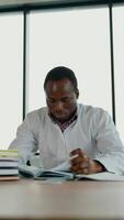 Black guy nursing student intern is preparing for the exam. Vertical video