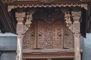 Close up view of an old wooden door of a hindu temple. photo