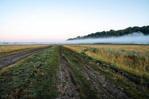 mountain view of fog in the early morning, nature of Russia, fog below, travel in nature, summer landscape, forest and mountains photo