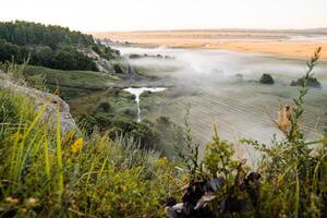 mountain view of fog in the early morning, nature of Russia, fog below, travel in nature, summer landscape, forest and mountains photo