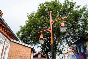 street lamp post made in a design style, creative execution of a good idea for street lighting, against the sky photo