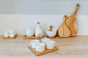 white tea set is in the kitchen, kitchen utensils, four cups photo