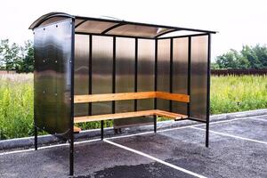 bus stop in a rural village, made of brown polycarbonate, outdoors photo