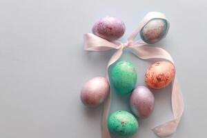 Decorated Easter eggs with bow top view photo