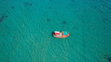 Solitary Orange Boat on Tranquil Sea photo