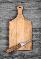 Cutting board and a kitchen knife on photo