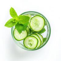 AI generated A glass of water infused with cucumber slices and a sprig of mint top view isolated on a transparent background photo